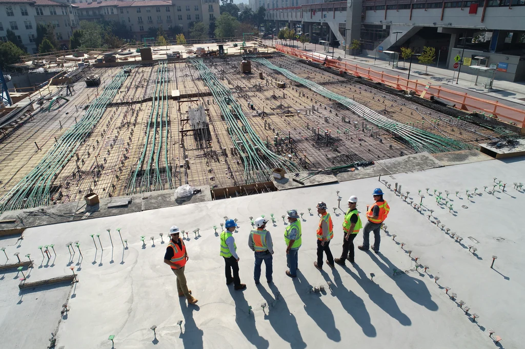 Illustrative photo of hard-hat wearers on a construction slab, not a McGill’s project