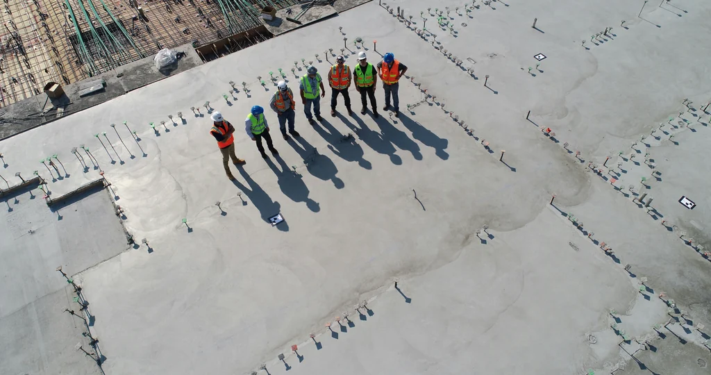 Illustrative construction workers on a concrete slab, not McGill’s staff
